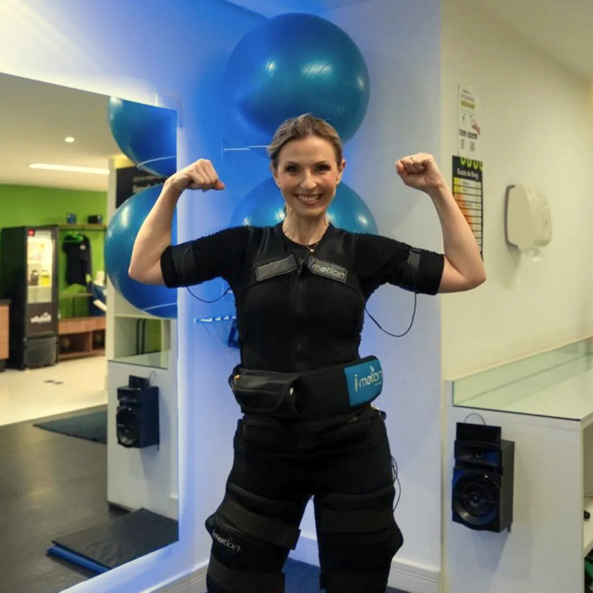 Aluna sorrindo com traje de eletroestimulação na BodyBe